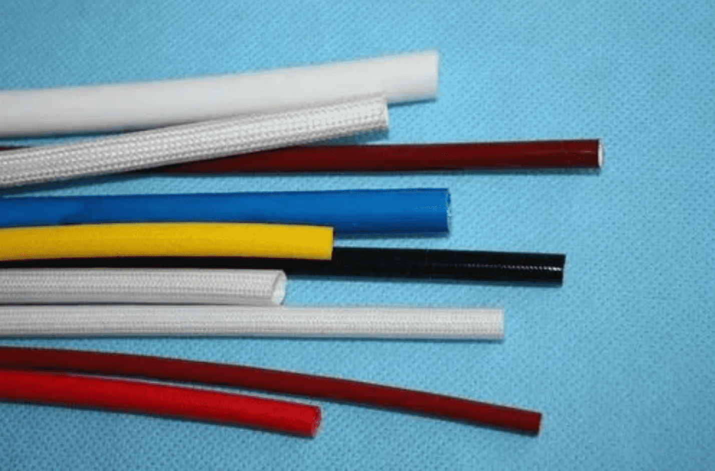 What are the main materials used for producing silicone glass fiber sleeves